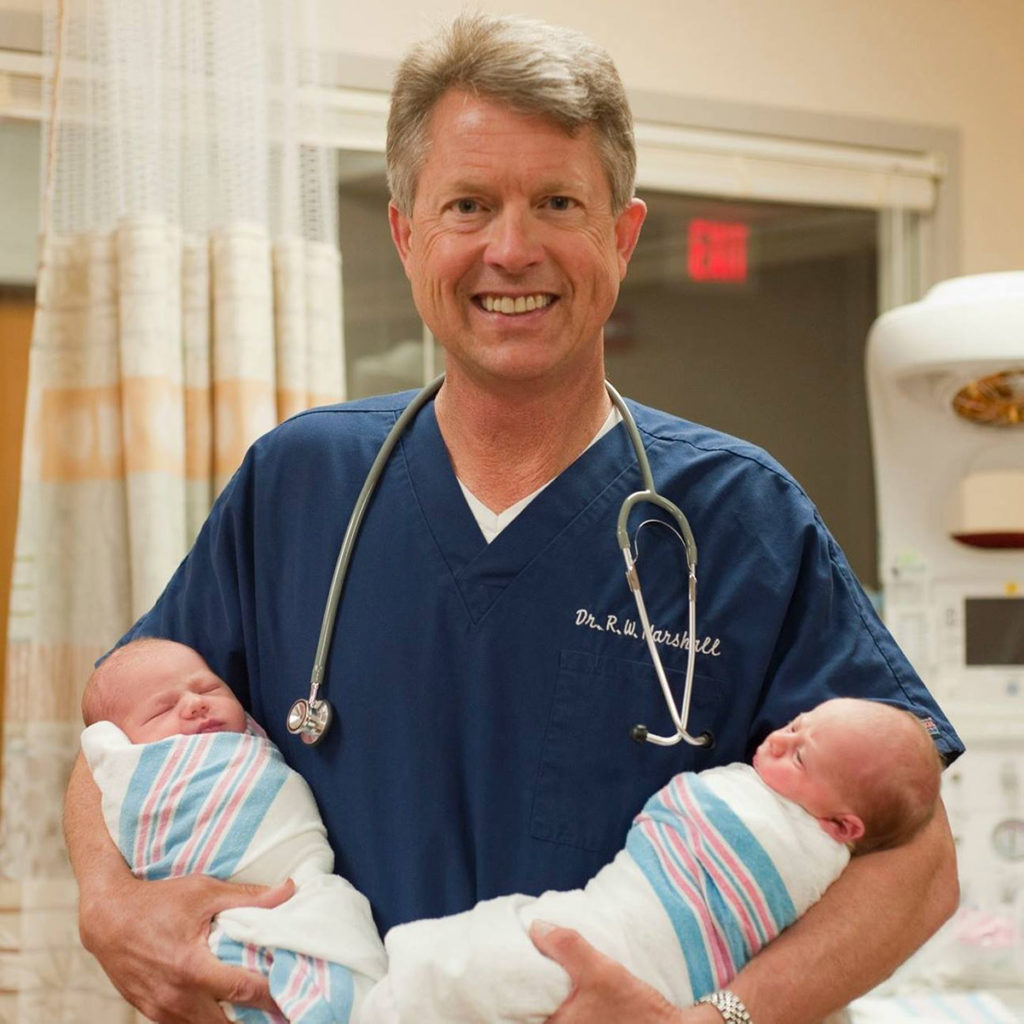 Senator Roger Marshall MD holding babies